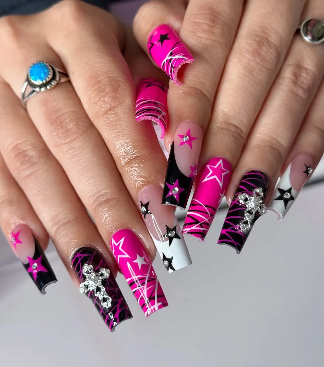 Extra-Long Pink-and-Black Star Nails with Rhinestone Clusters