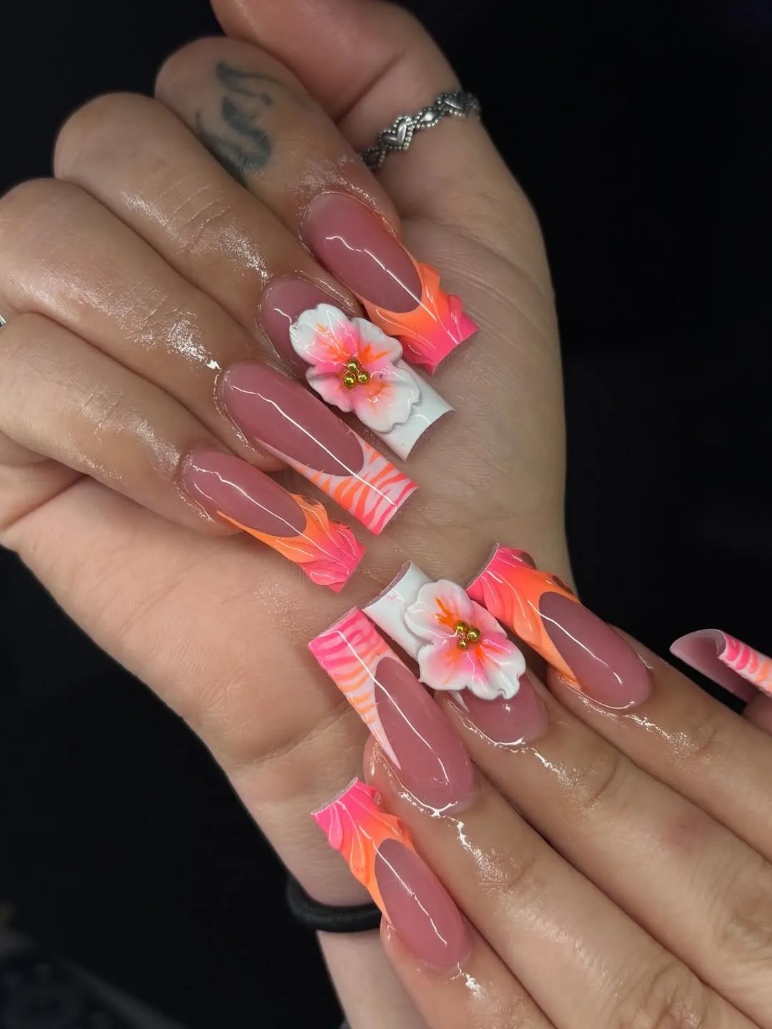 Nude base with neon tips and 3D floral accents