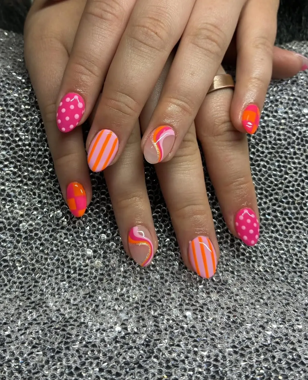 Polka dots, stripes, and curved lines in pink and orange