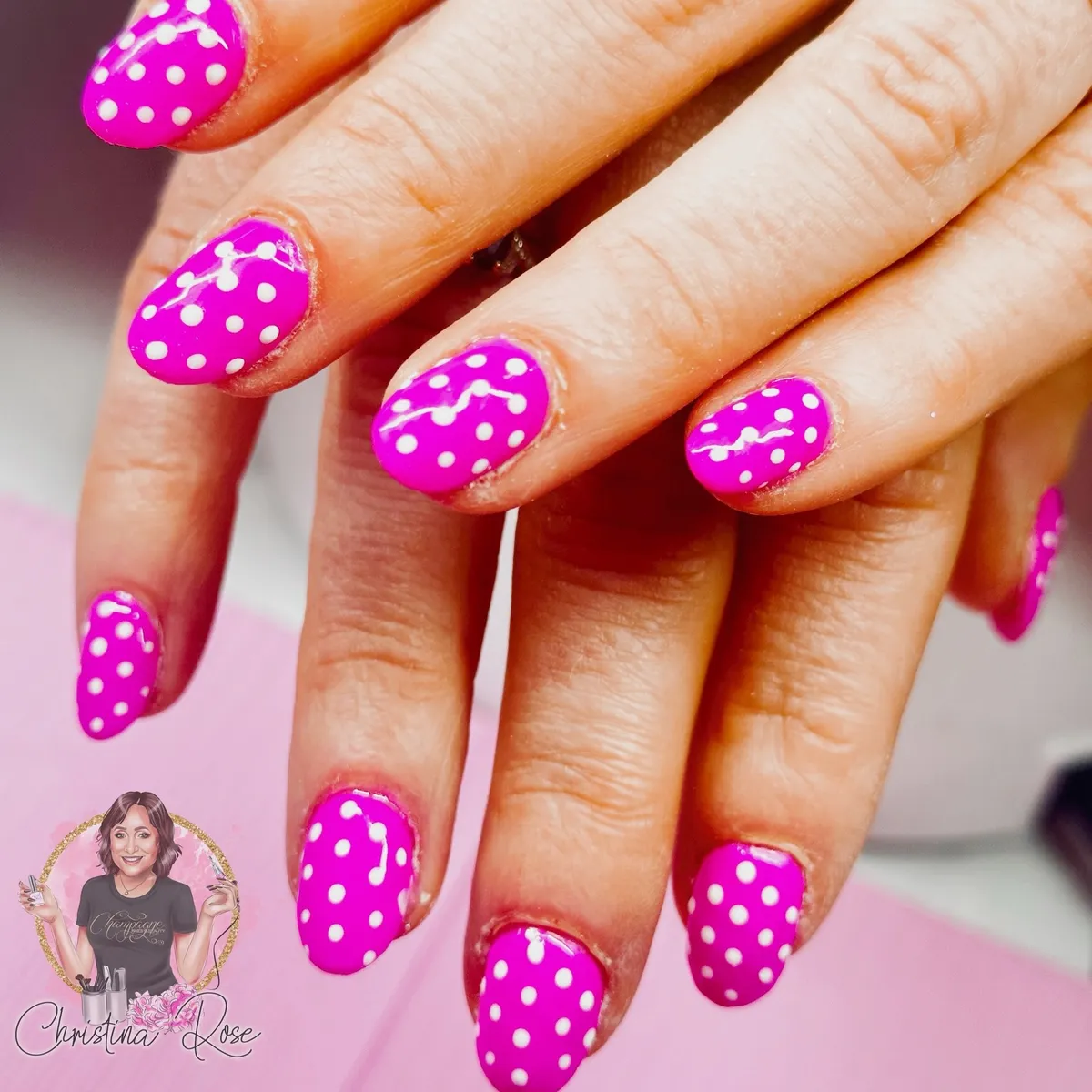 Hot pink nails with white polka dots