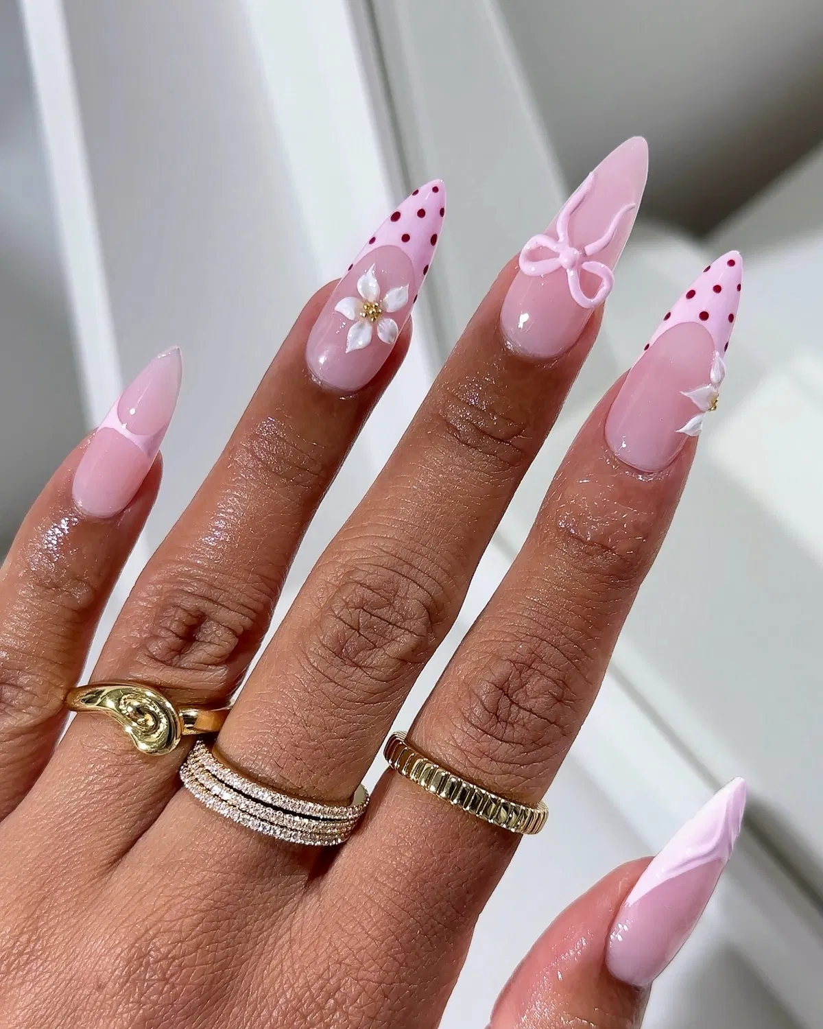 Pink polka-dot tips with raised flowers and bow accents