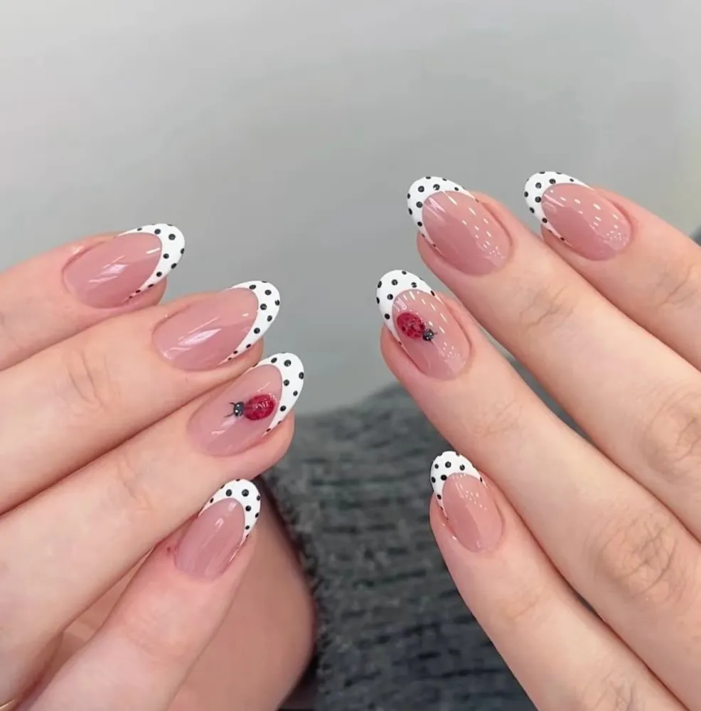 Short polka-dot French tips with tiny ladybug accents