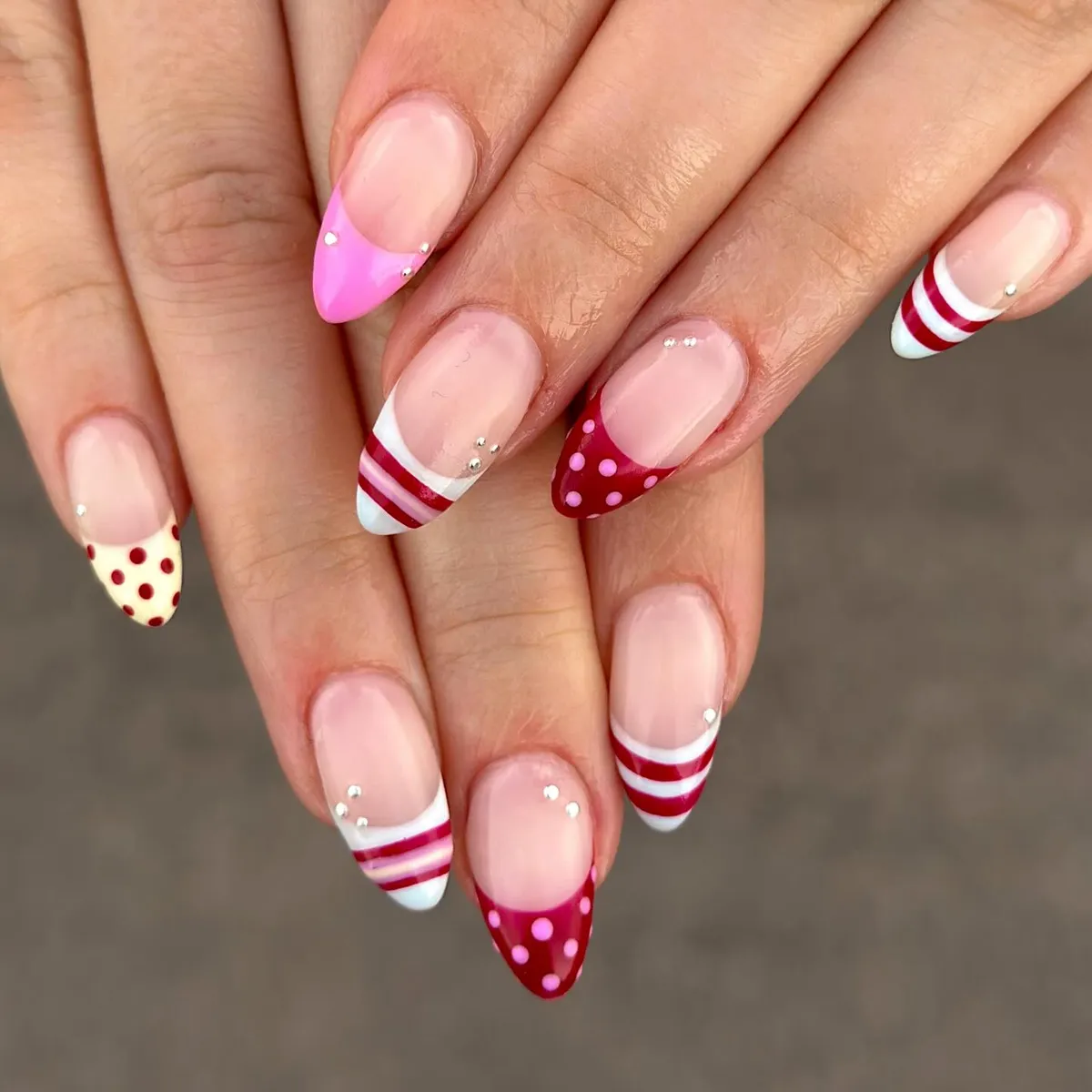 Mixed striped and polka-dot French tips with small studs