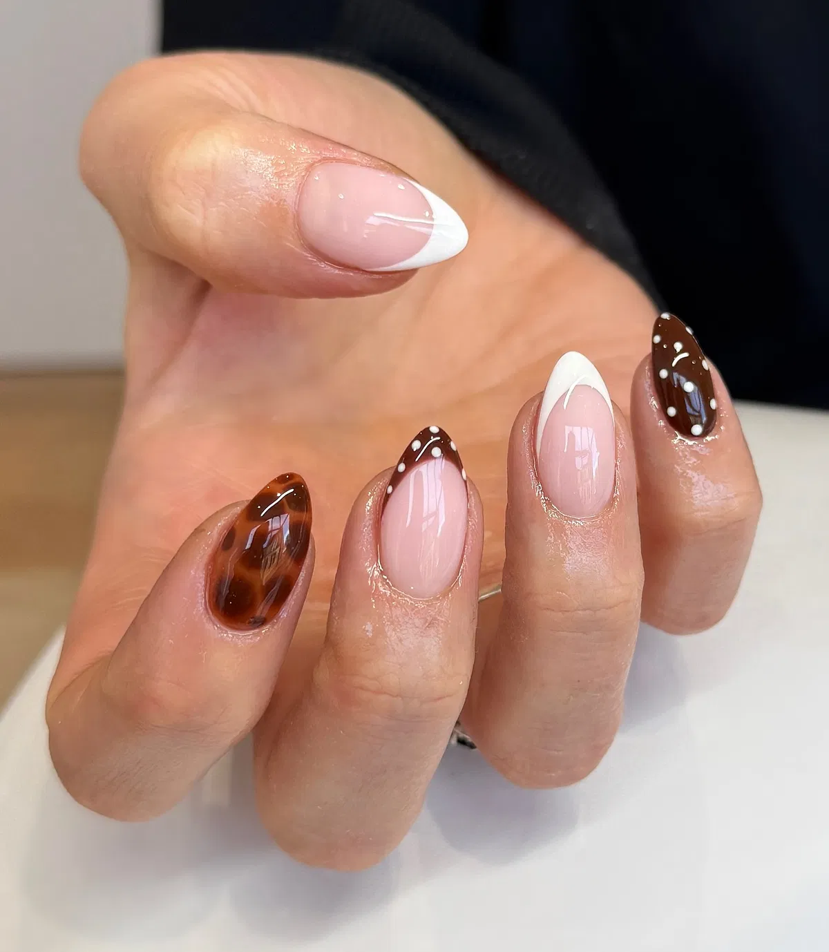 Nude base with white tips and brown polka-dot French tips