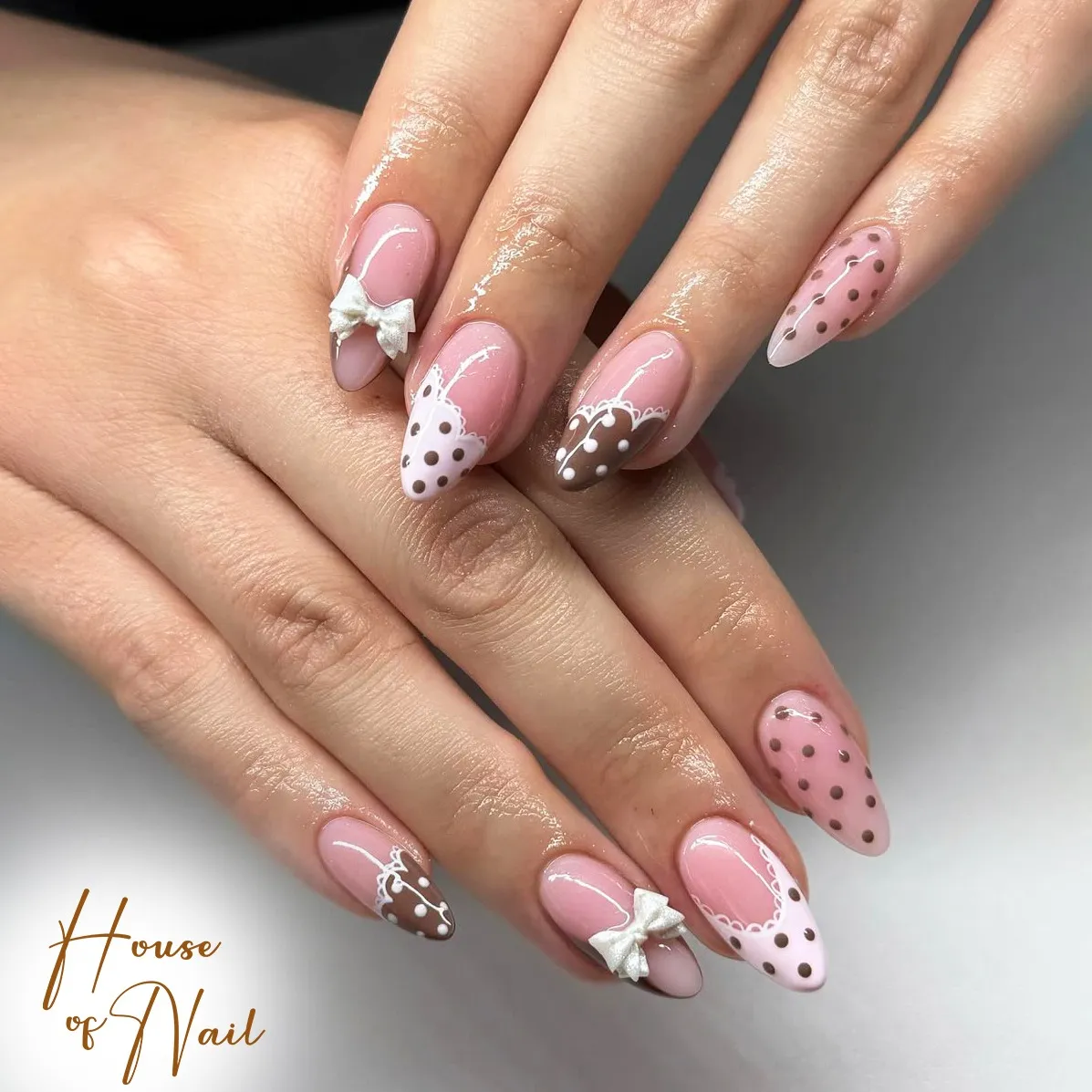 Pink base with lace-edged polka-dot tips and bow accents