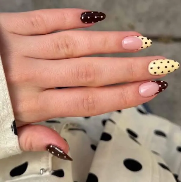 Cream polka-dot nails with brown dotted French tips