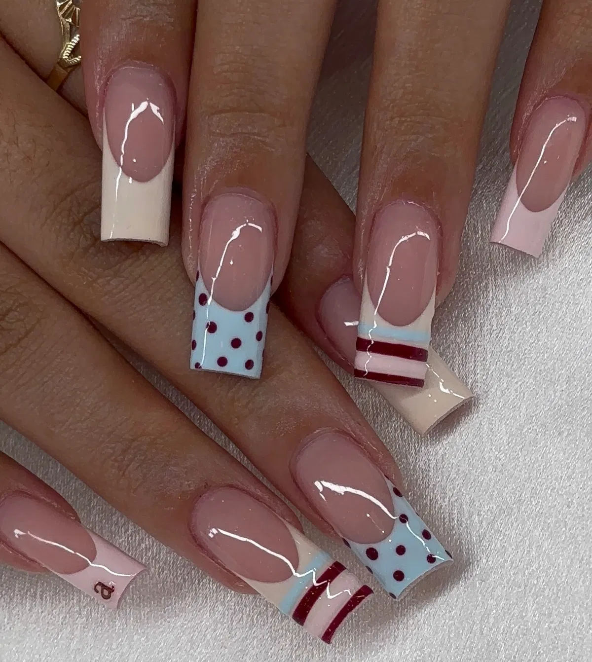 Light blue polka-dot tips with red stripe accents