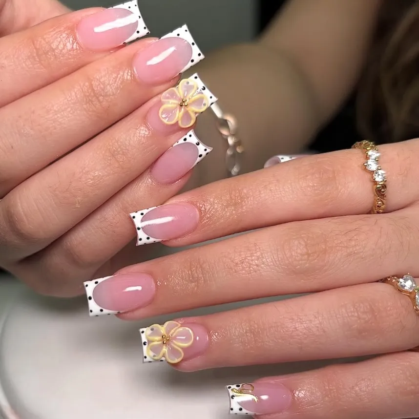 Polka-dot French tips with yellow flower accents