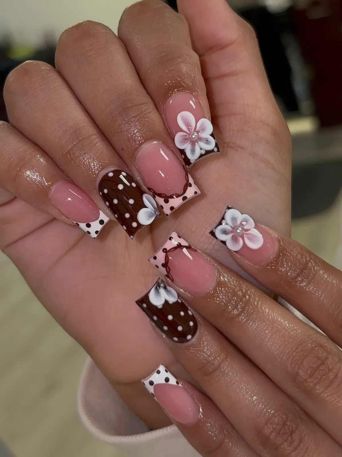 Brown-and-white polka dot tips with floral accents
