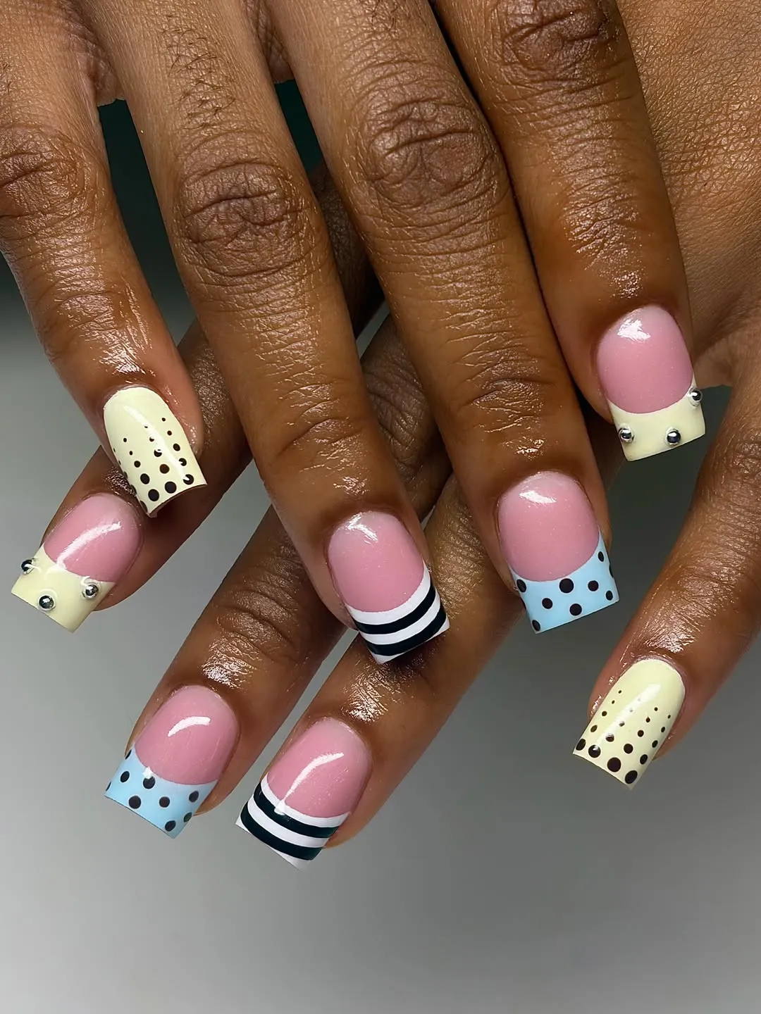 Pastel polka-dot tips with striped accent and studs