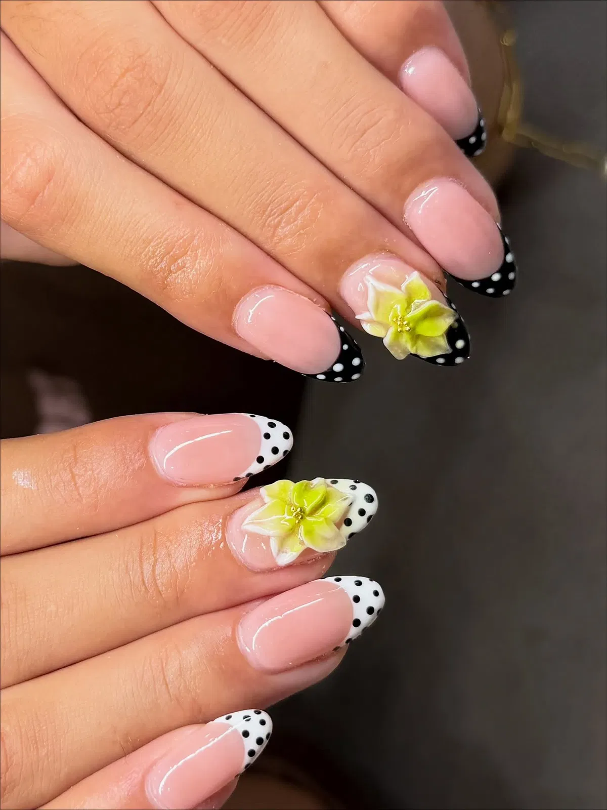 Black polka-dot French tips with floral accents
