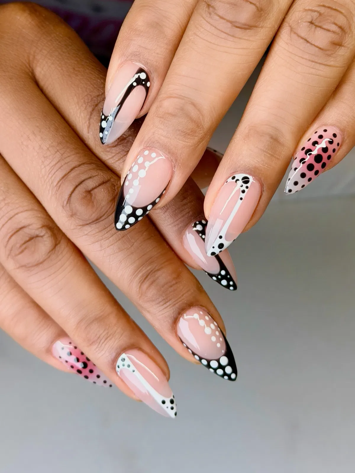 Graphic black-and-white polka-dot French tips on stiletto nails