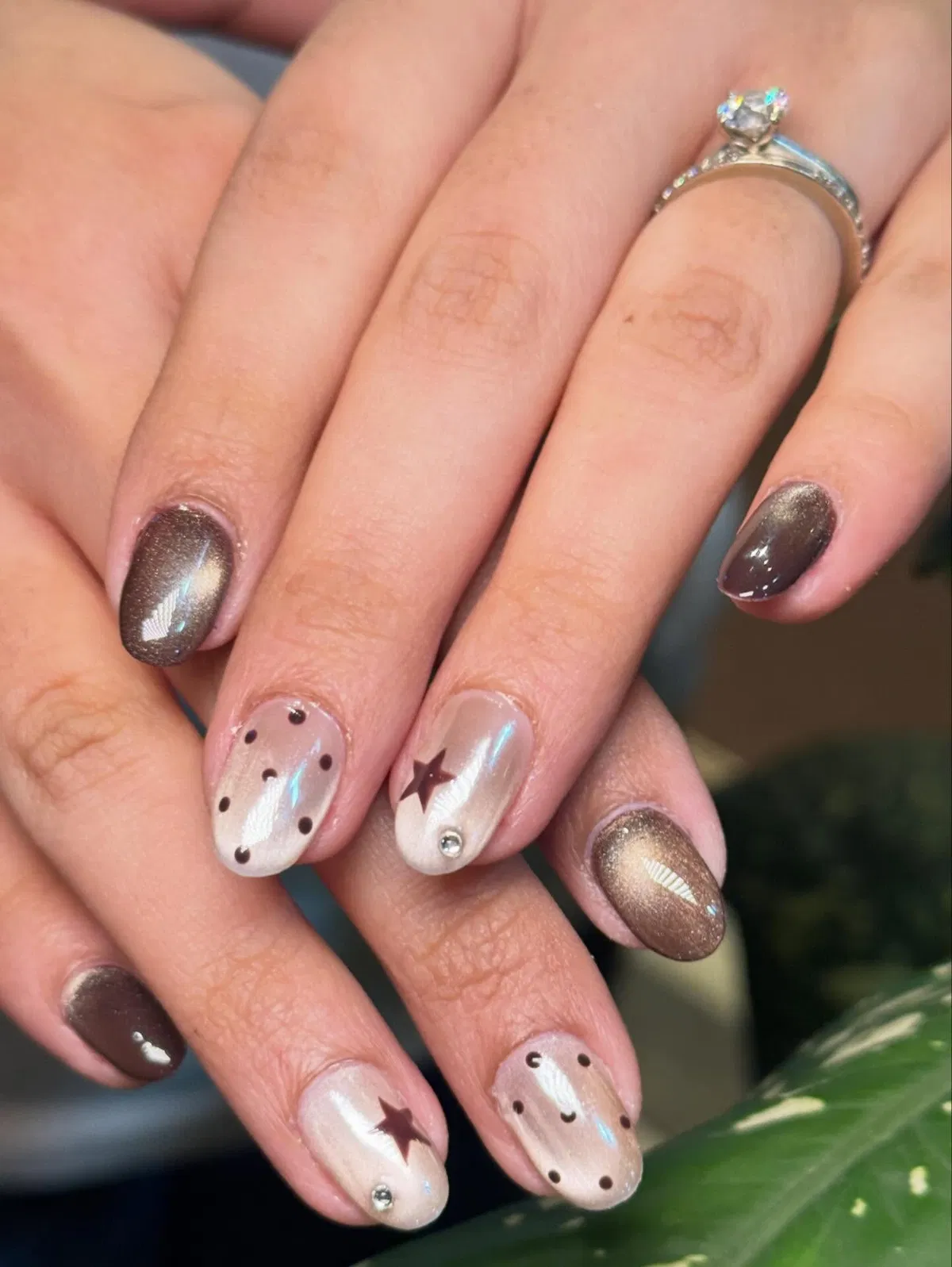 Metallic browns with dotted and star accent nails