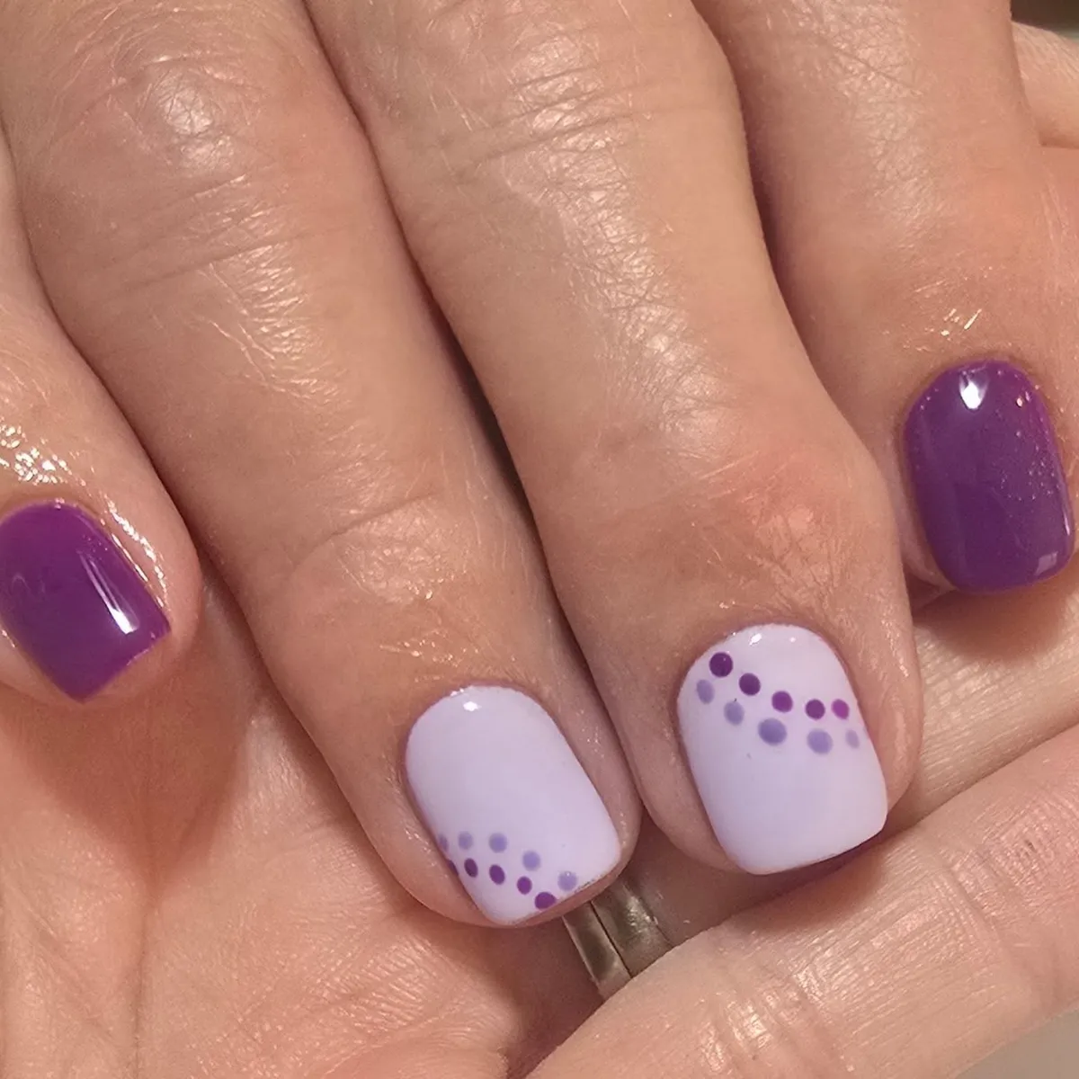 Pale lavender nails with corner dot clusters