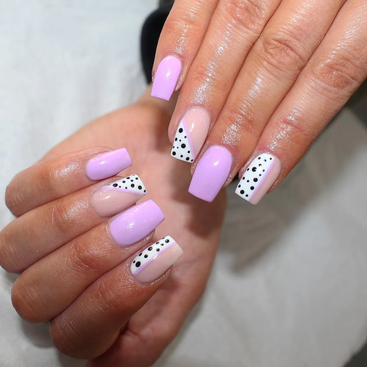 Glossy lilac squares with black polka-dot panels and diagonal tips