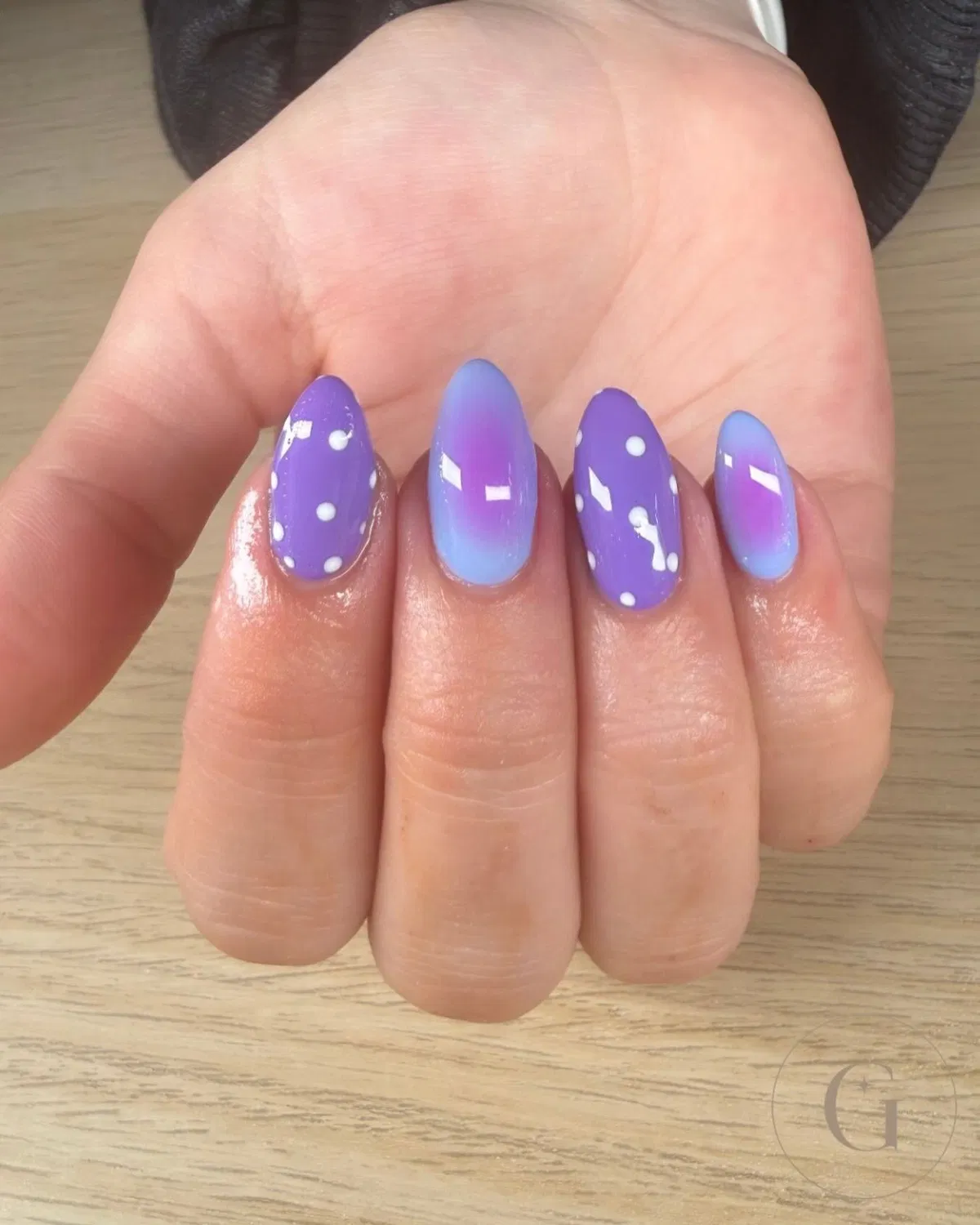 Purple polka dots paired with blue-to-purple gradient nails