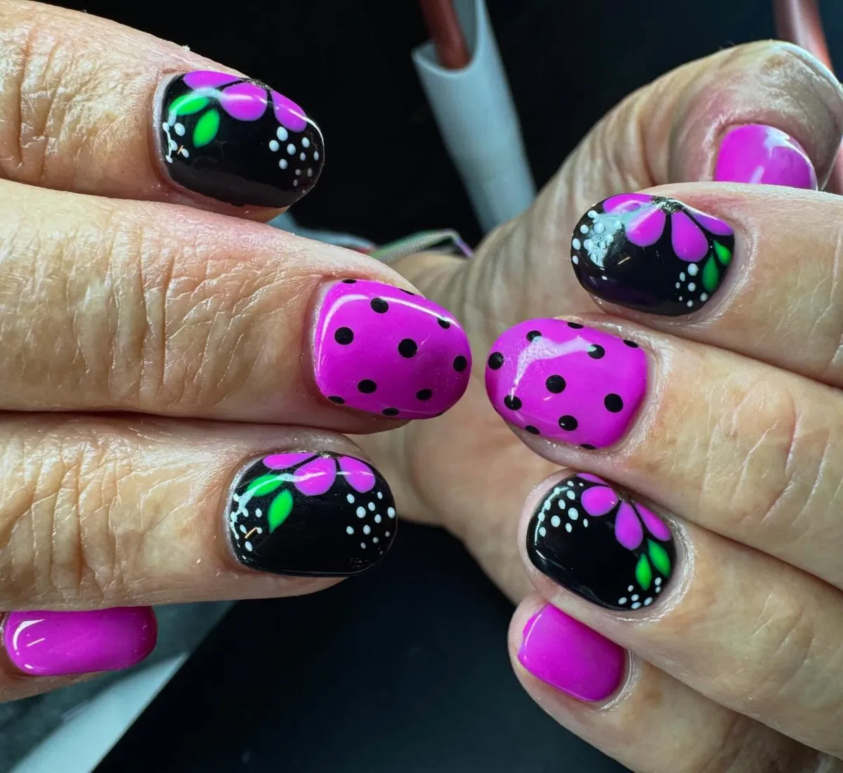 Hot Pink and Black Nails with Polka Dots and Floral Accents