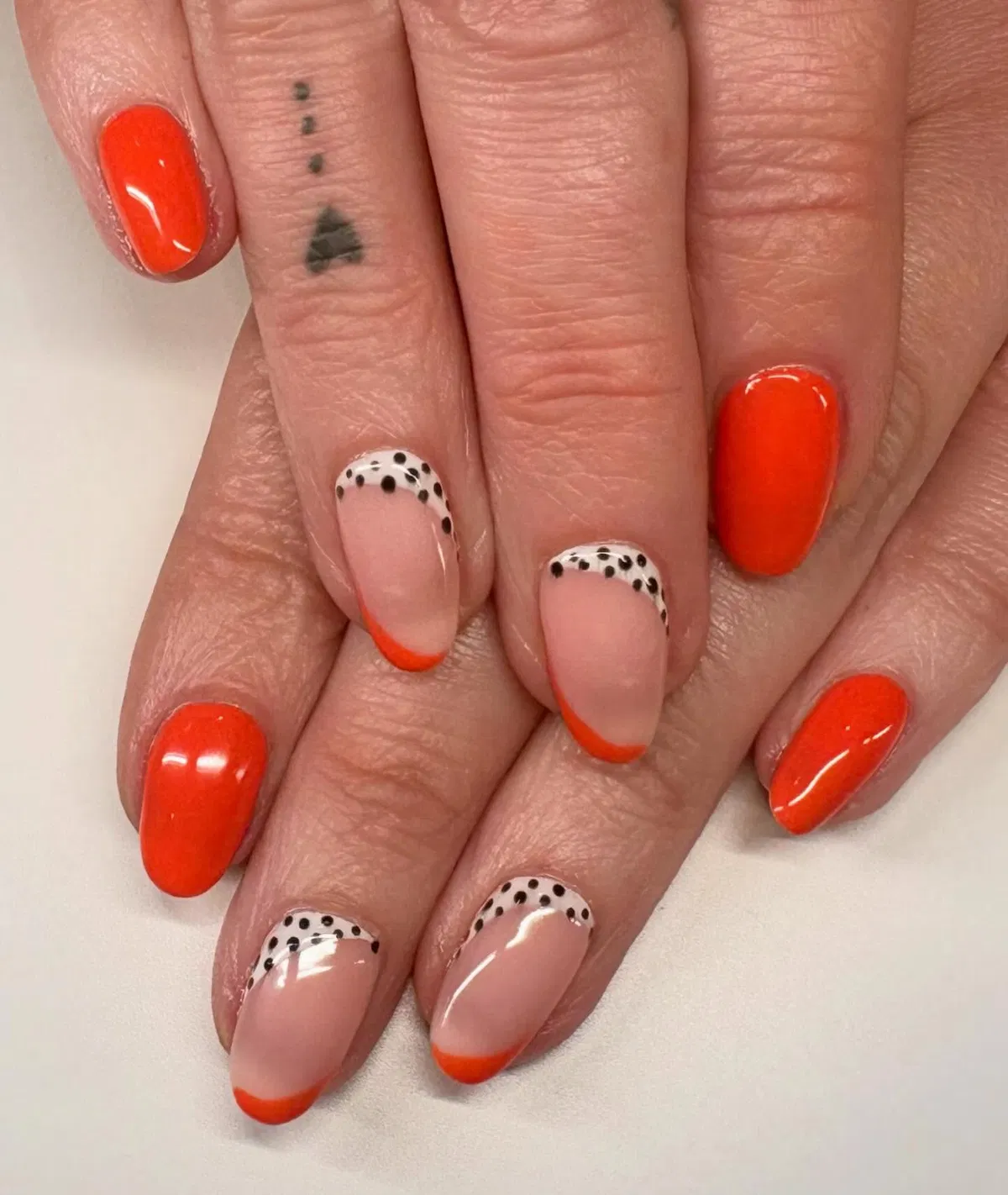 Orange-red solids with black-dotted French accents