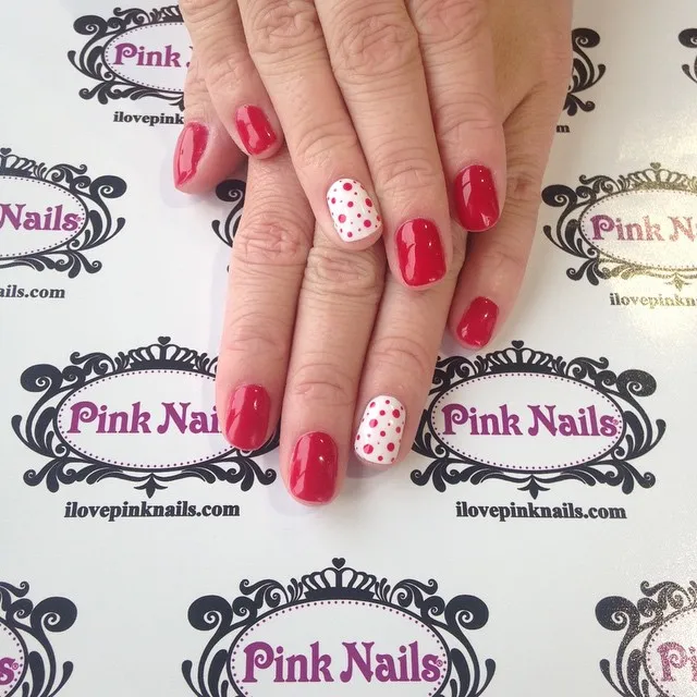 Solid red set with white-and-red polka-dot accent nails