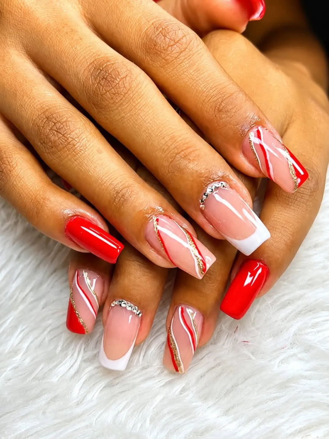 Long red set with wavy lines, white tips, and rhinestones