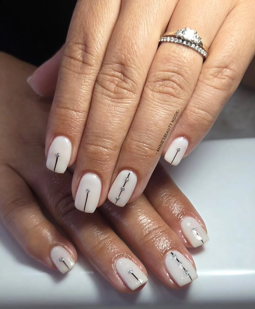 White short square nails with black line and rhinestones