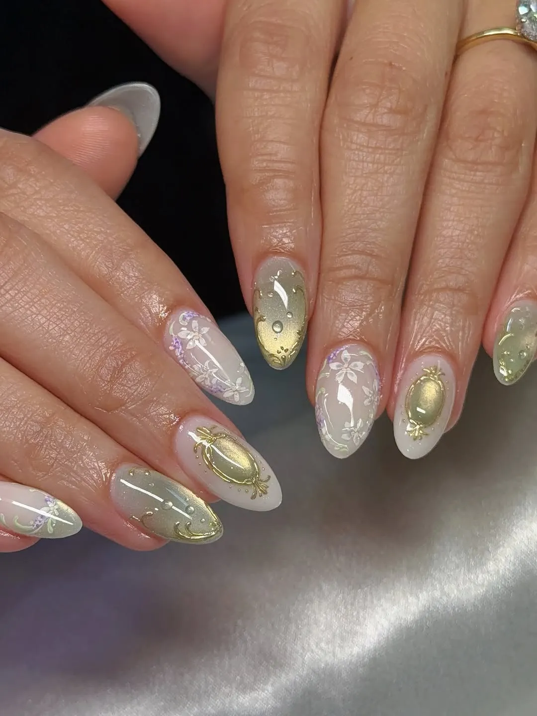 Translucent nude almonds with gold frames and floral details