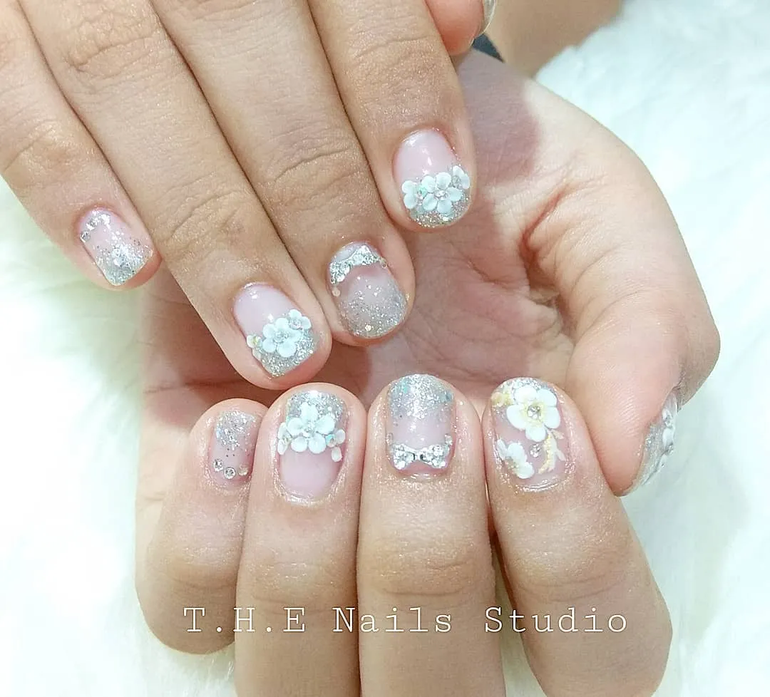 Short pink nails with silver glitter and 3D flowers
