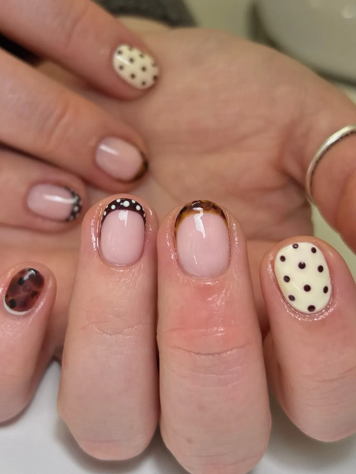 Pale pink with brown borders and mixed polka dot accents