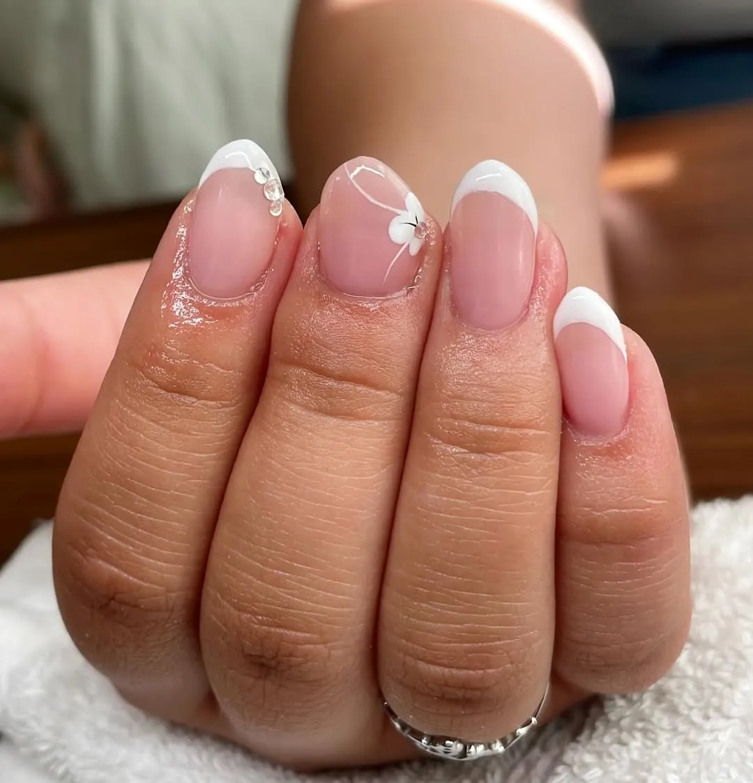 Soft French tips with a tiny floral accent