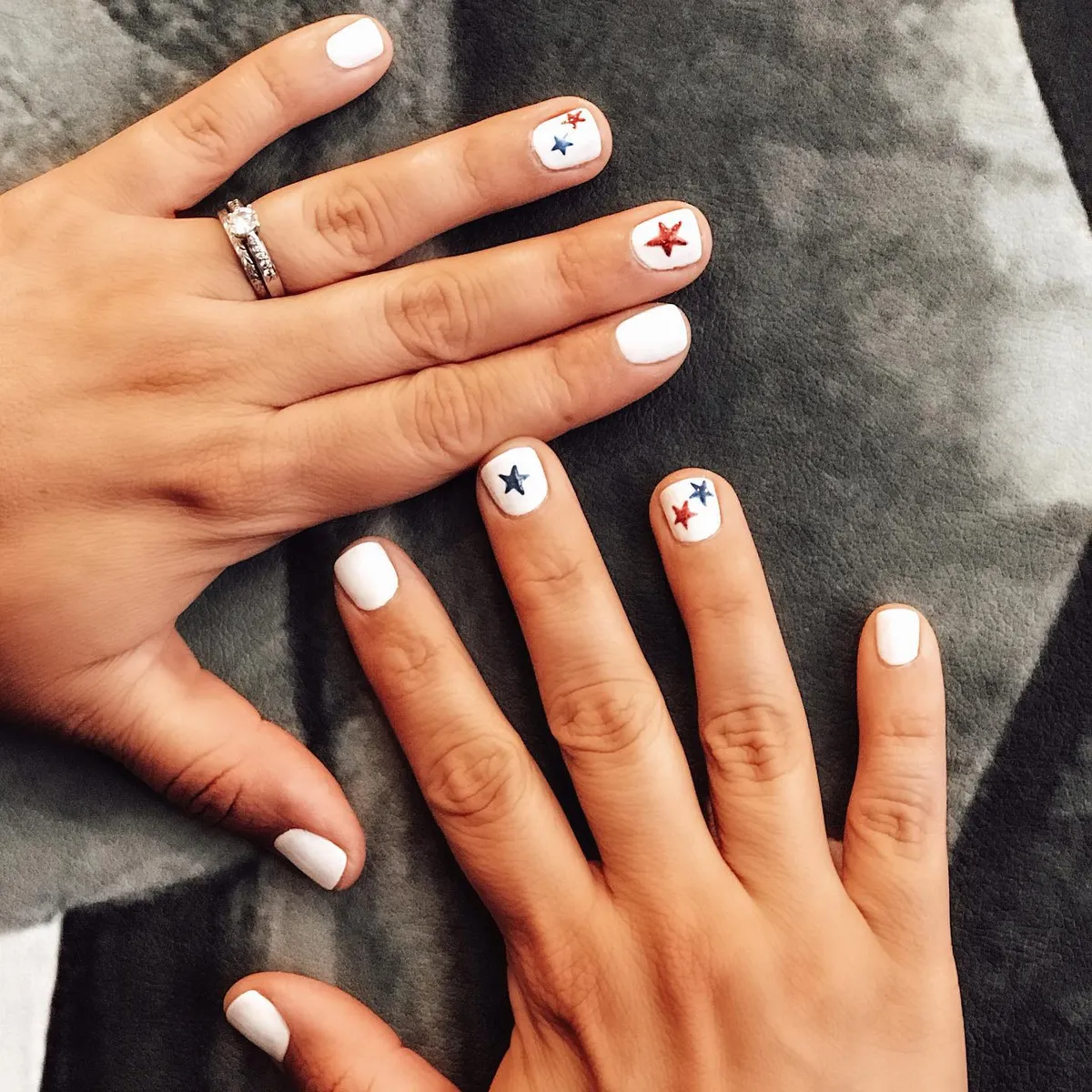White nails with small red and blue star accents