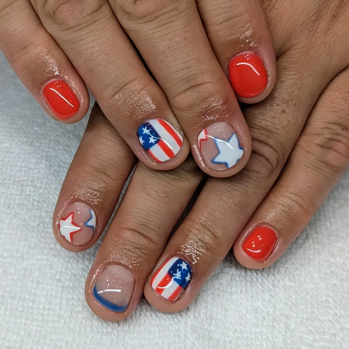 Mix of bright red solids and star/stripe accent nails