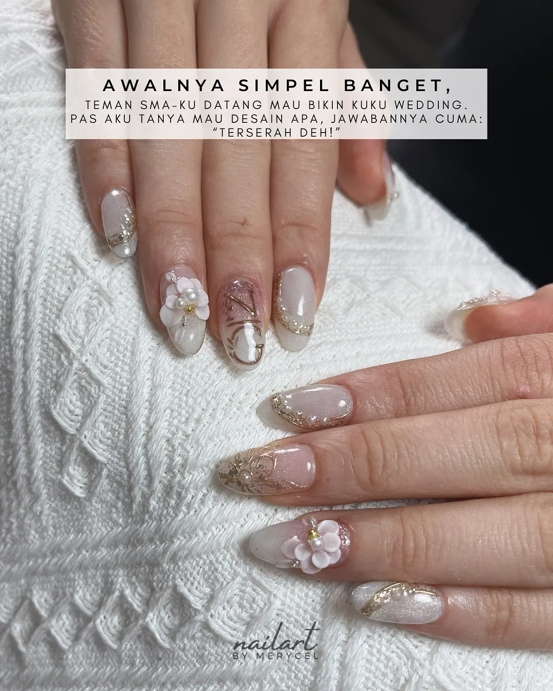 Nude-to-milky white nails with gold glitter edging and 3D floral accents