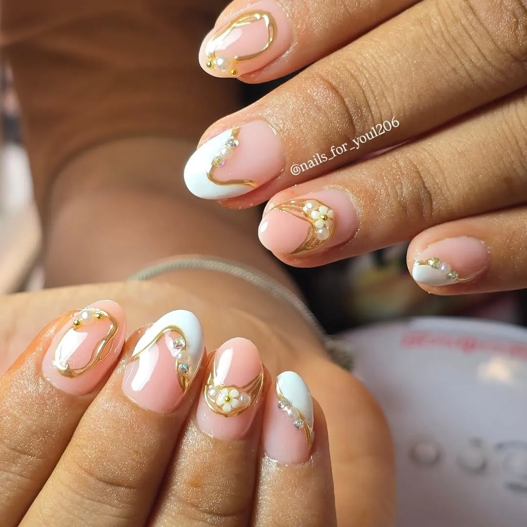 Pale pink with white curves, gold outlines, and small rhinestone accents