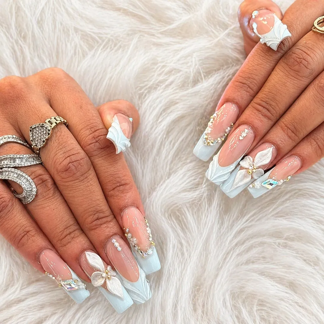 Nude-and-pale-blue square nails with 3D white florals and rhinestones