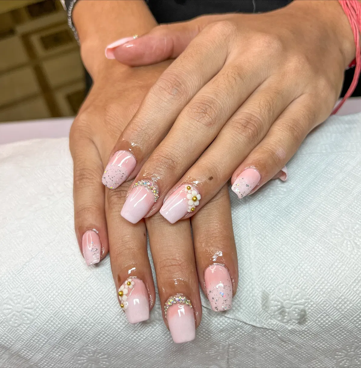 Light pink squares with glitter tips and bead/rhinestone accents