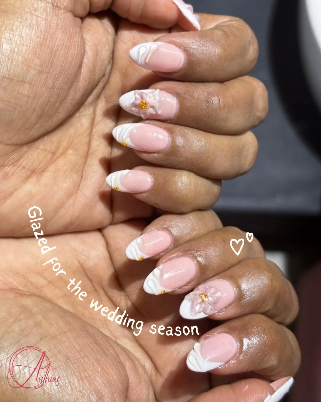 Pink almond French tips with raised white curves and 3D flowers