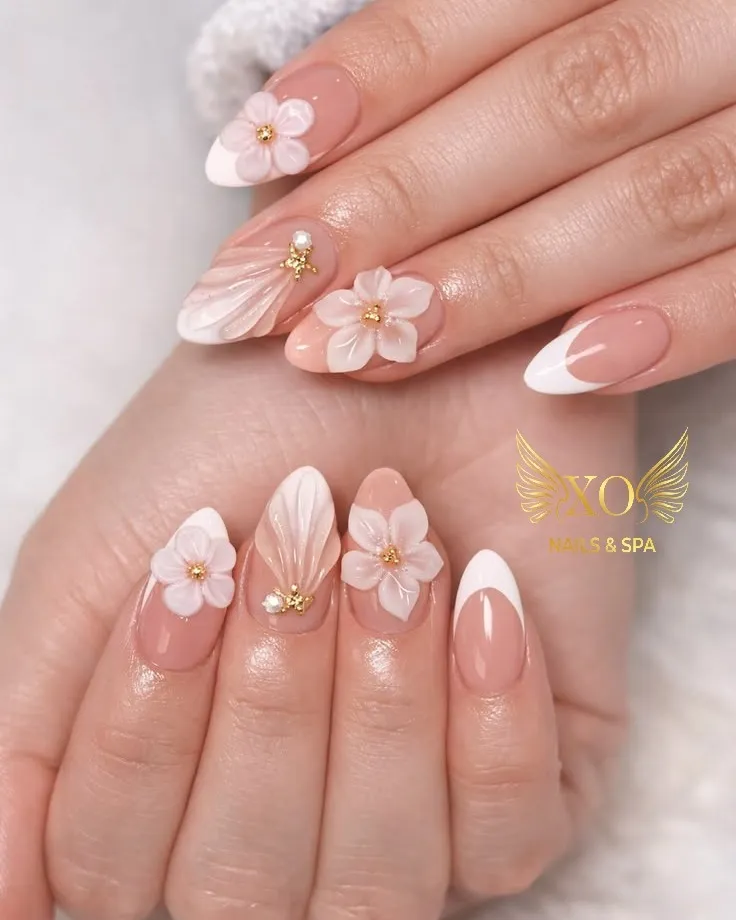 Nude-pink almond nails with white French tips and 3D flowers
