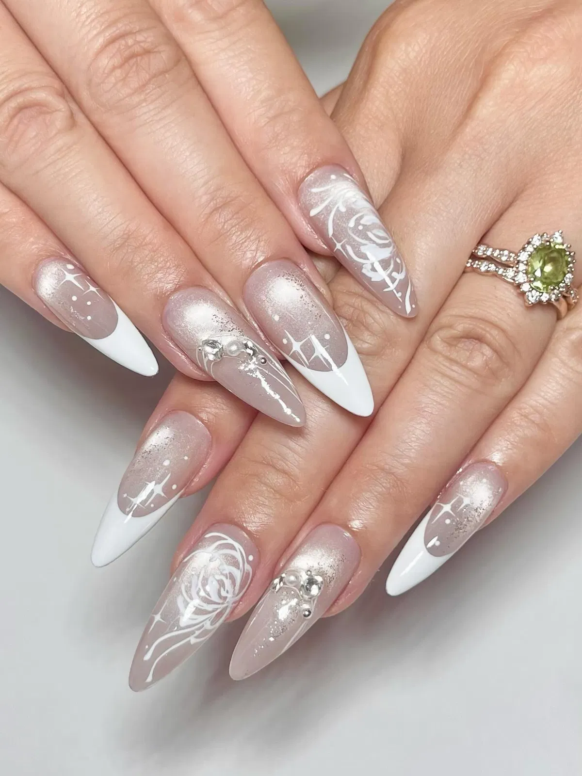 Shimmer ombré French tips with white roses and sparkle motifs