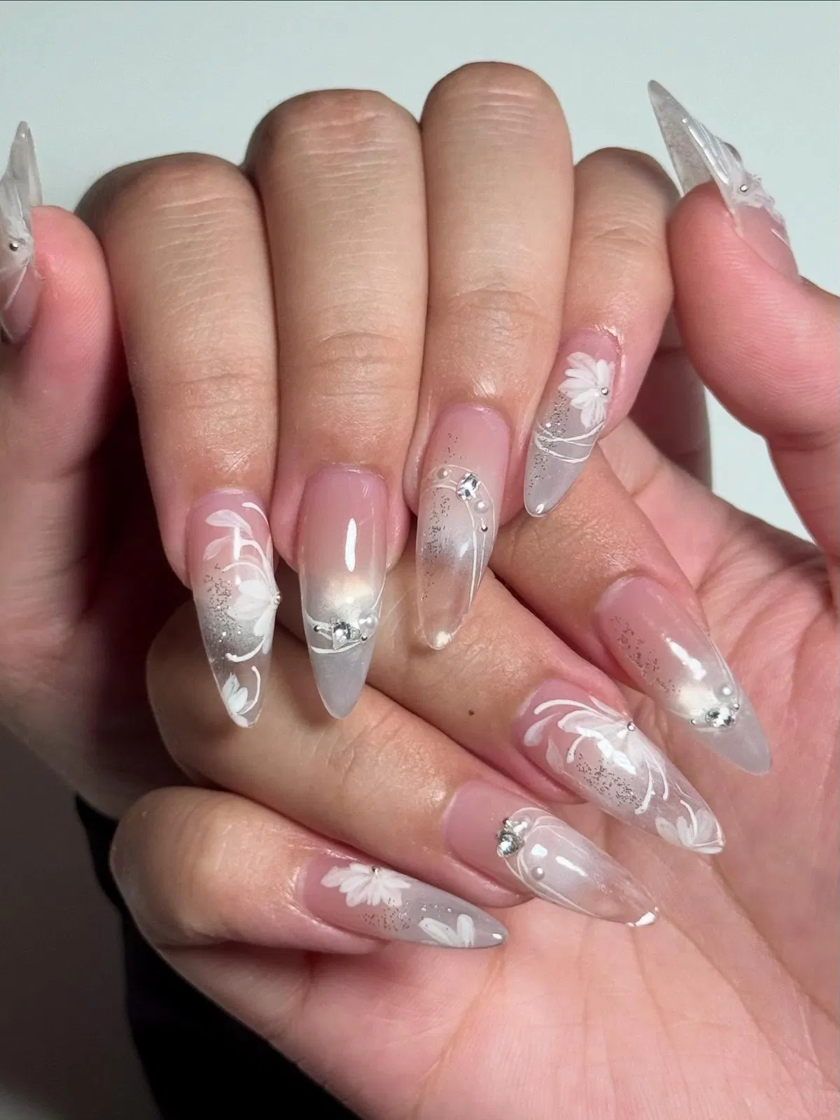 Sheer pink-to-translucent stiletto with white florals and glitter