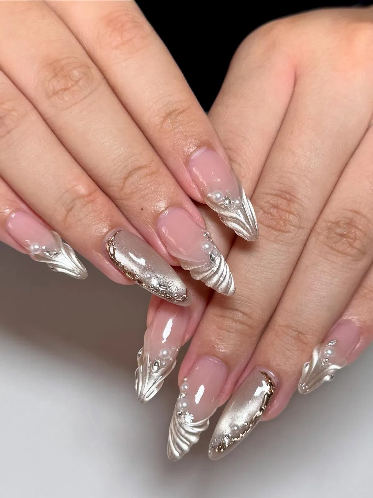 Nude and metallic silver sculpted tips with pearls