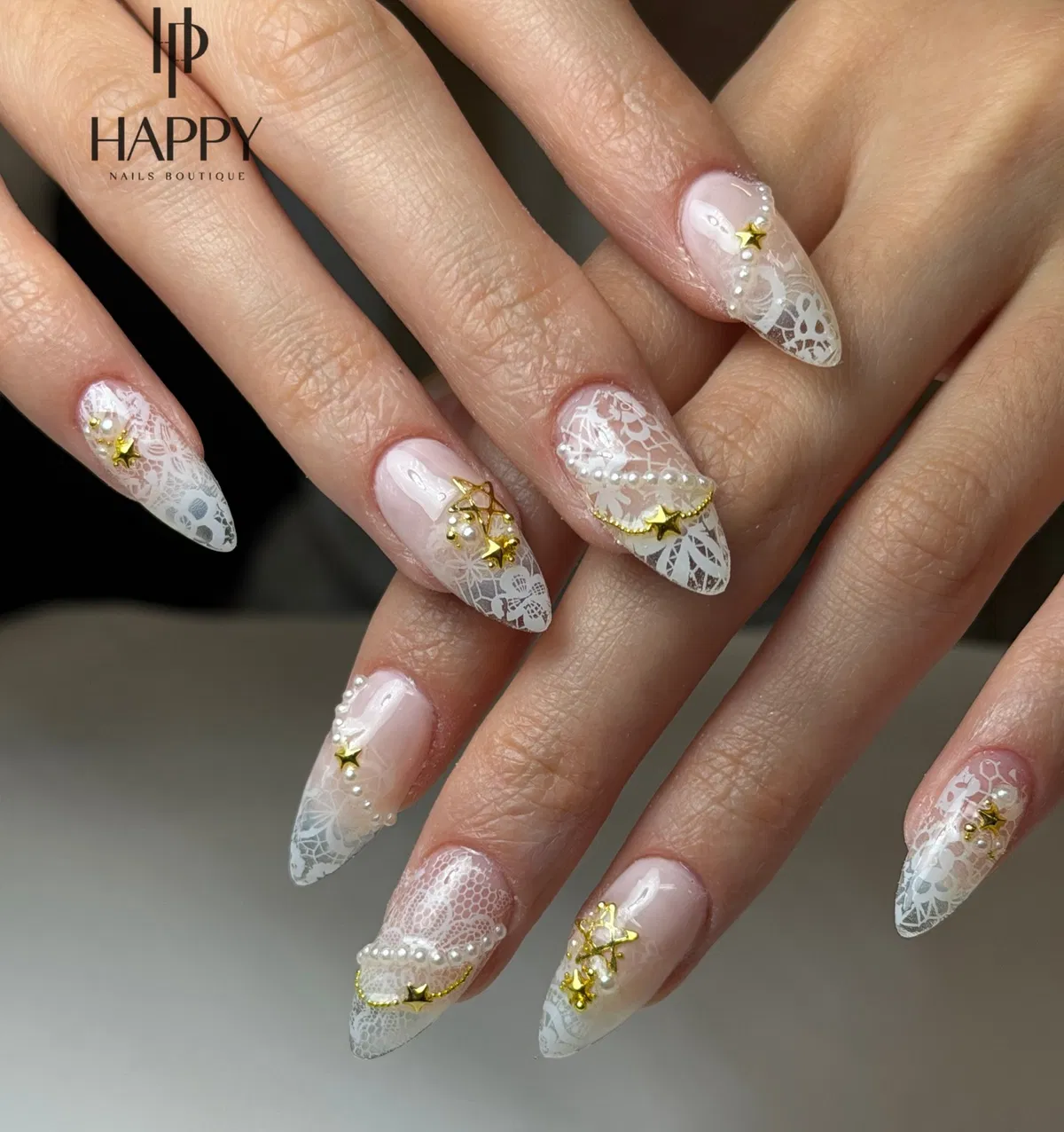 Lace-patterned stiletto tips with gold stars and pearls