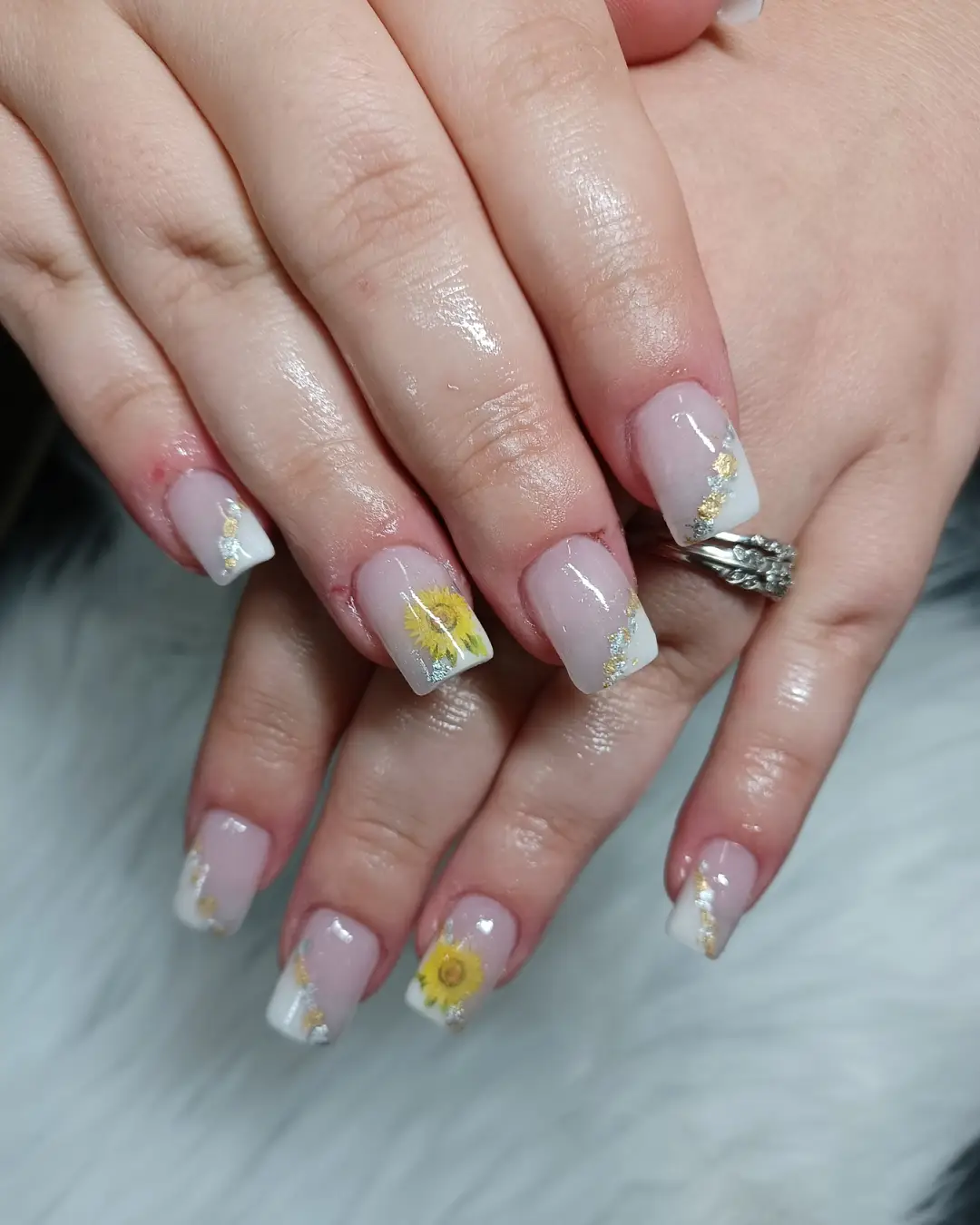Pale pink square nails with white tips, glitter diagonals, and yellow flowers