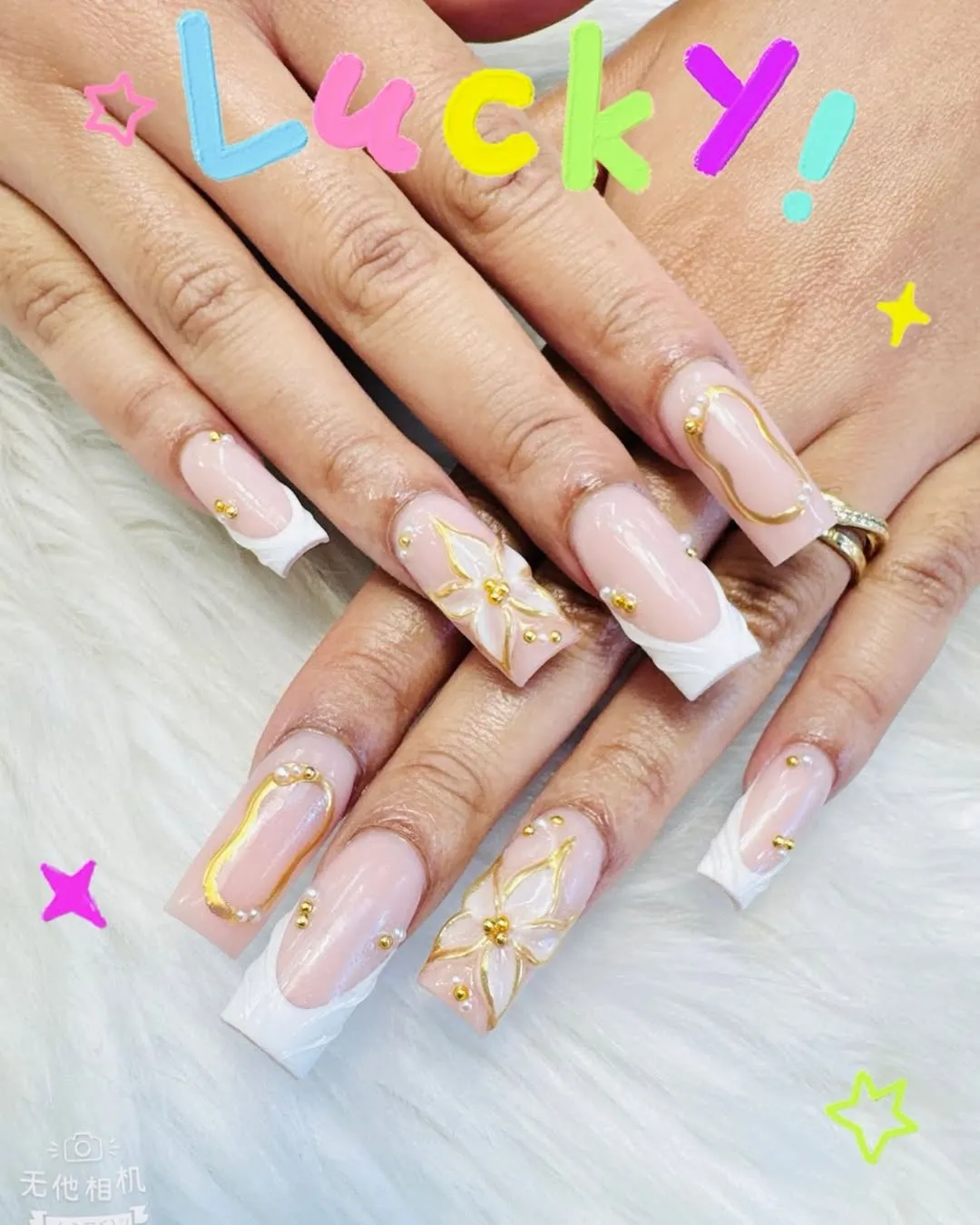 Nude-pink French tips with gold outline art and bead accents