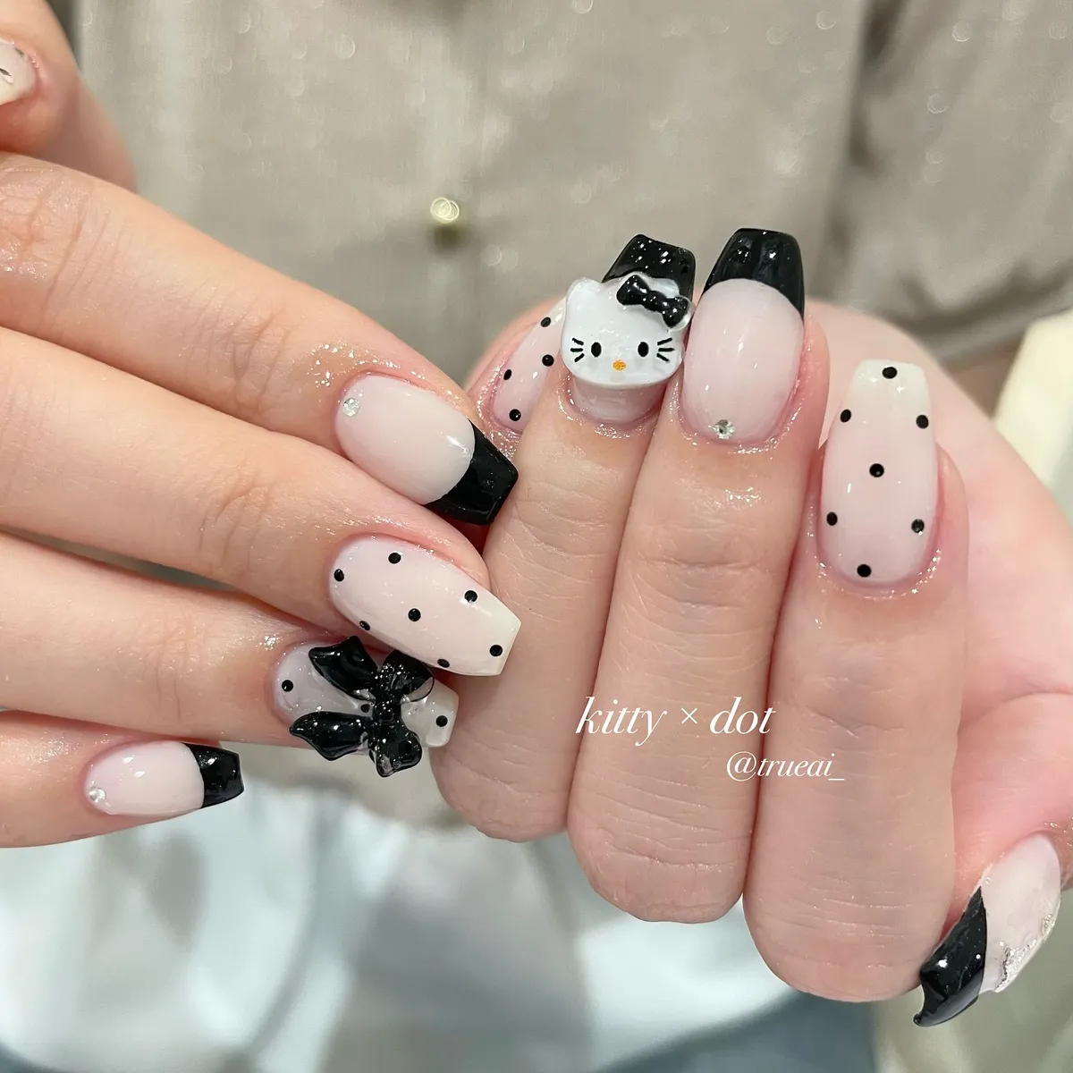 Pale pink base with black tips, polka dots, and 3D cat accent