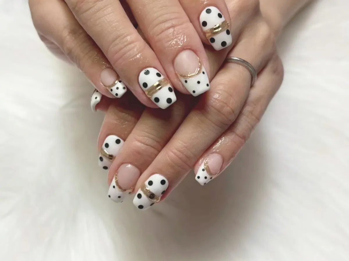 Short square polka dot French tips with gold line accents