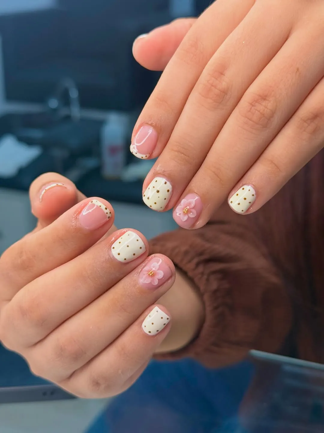 Cream Nails with Gold Dots and Pink Flower Accents