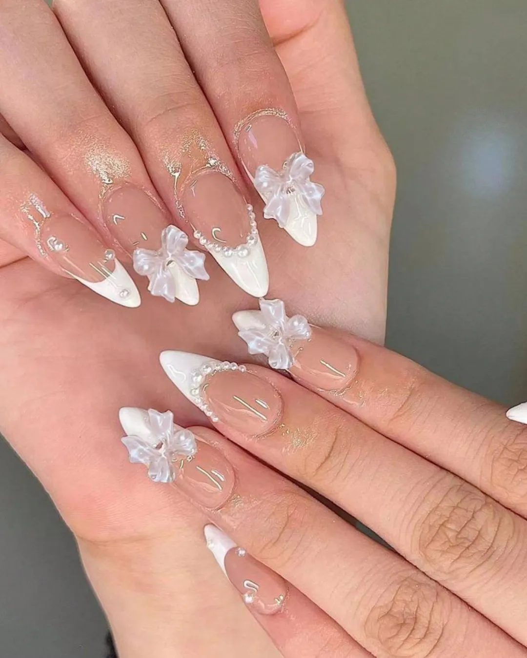 Nude stiletto French tips with translucent 3D bows