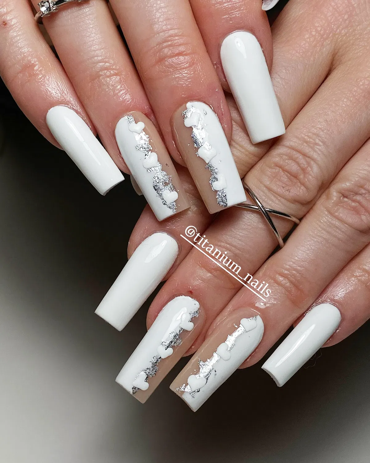 Glossy white coffin nails with silver-foil heart accents