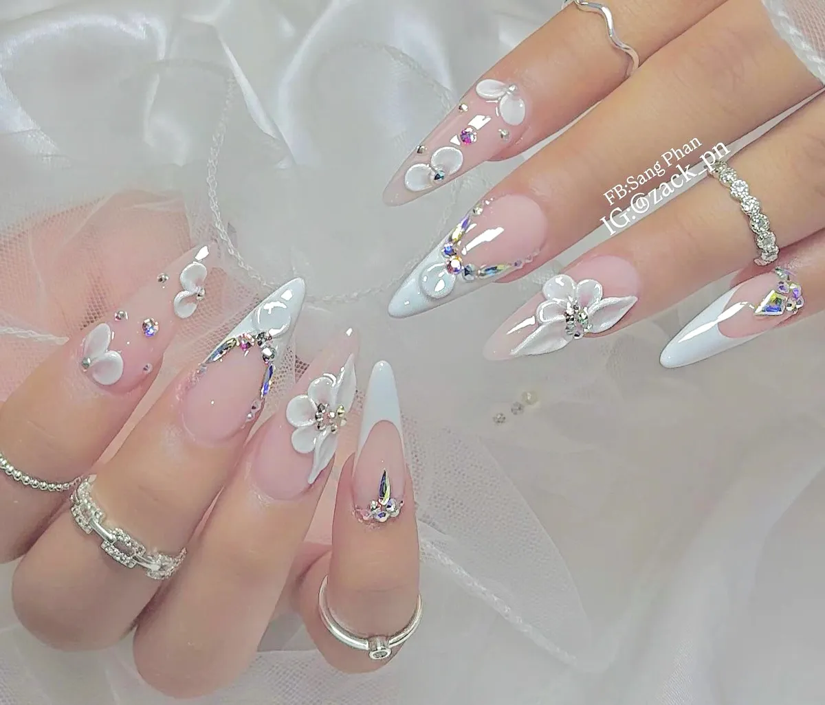 Stiletto French tips with 3D florals and rhinestone swirls