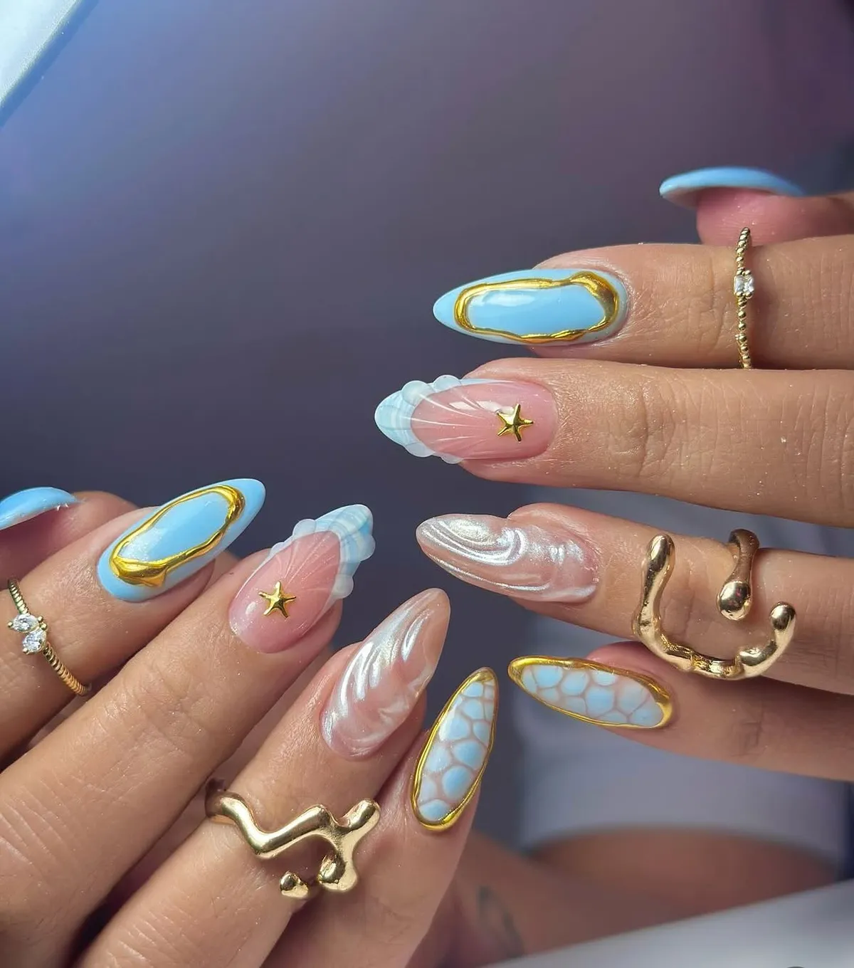 Sky blue ovals, gold stars, and layered white tips